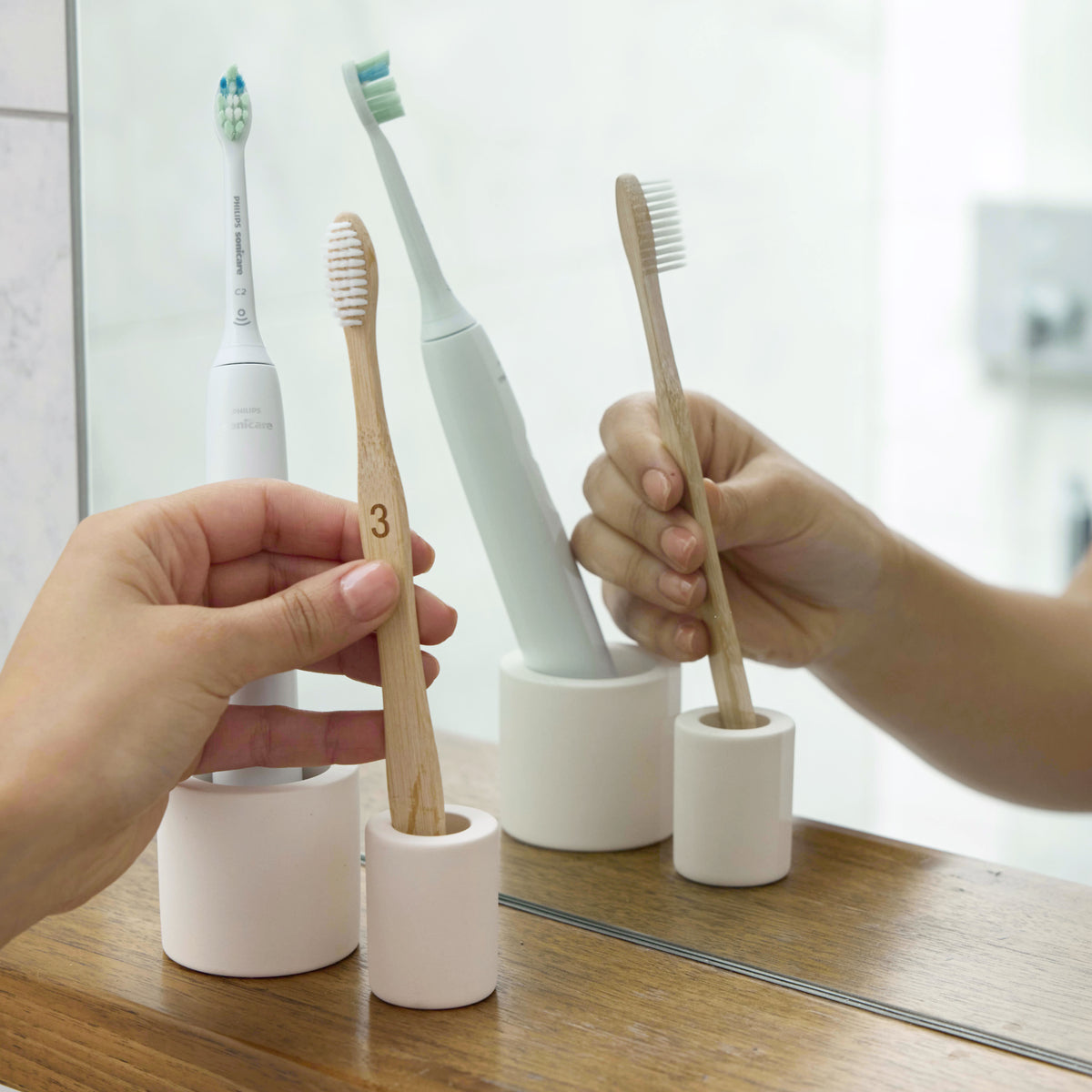 Soft Beige Small Toothbrush Holder with standard toothbrush and electric toothbrush. 
