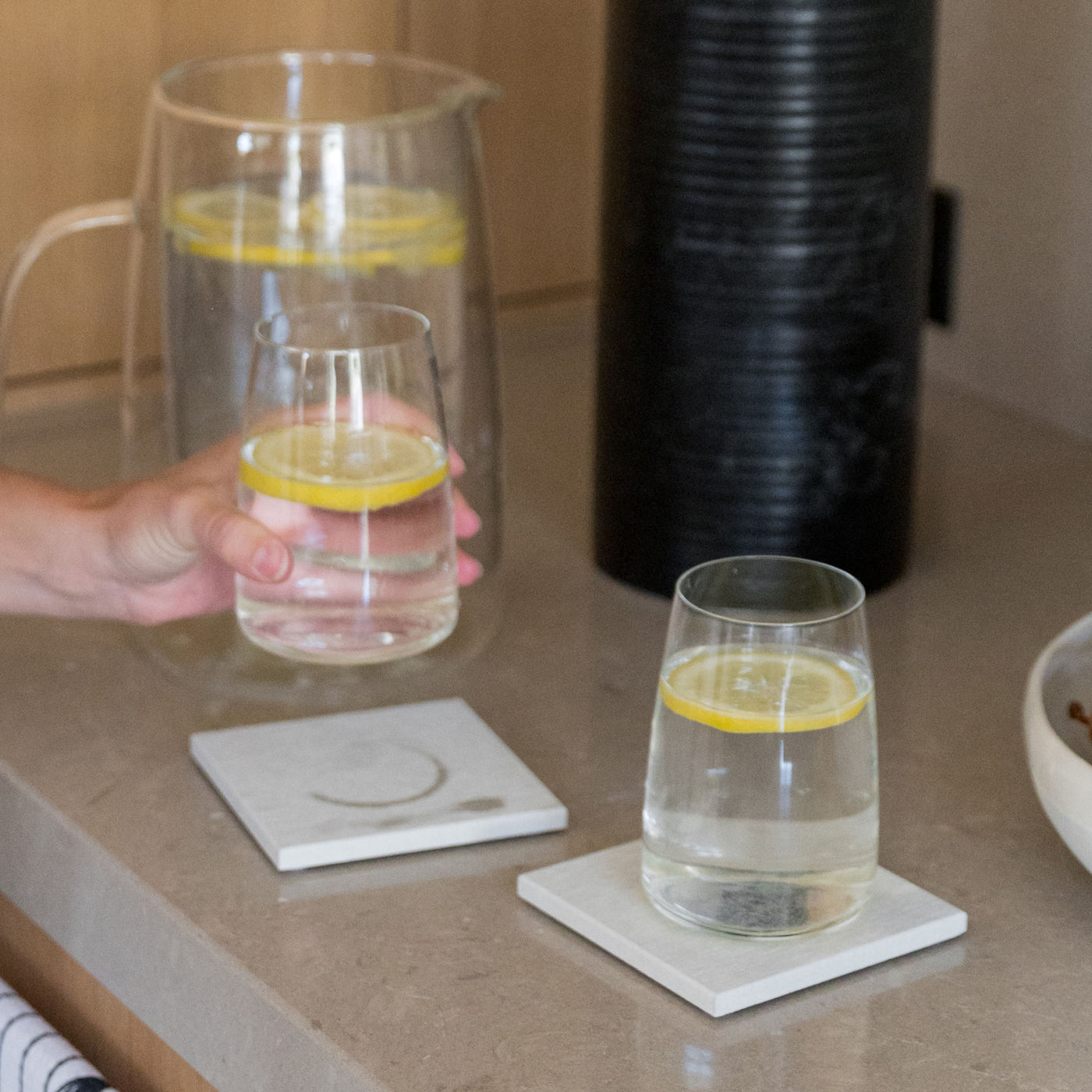 Large Sandstone Coasters with pitcher and cup protecting table from water rings. 