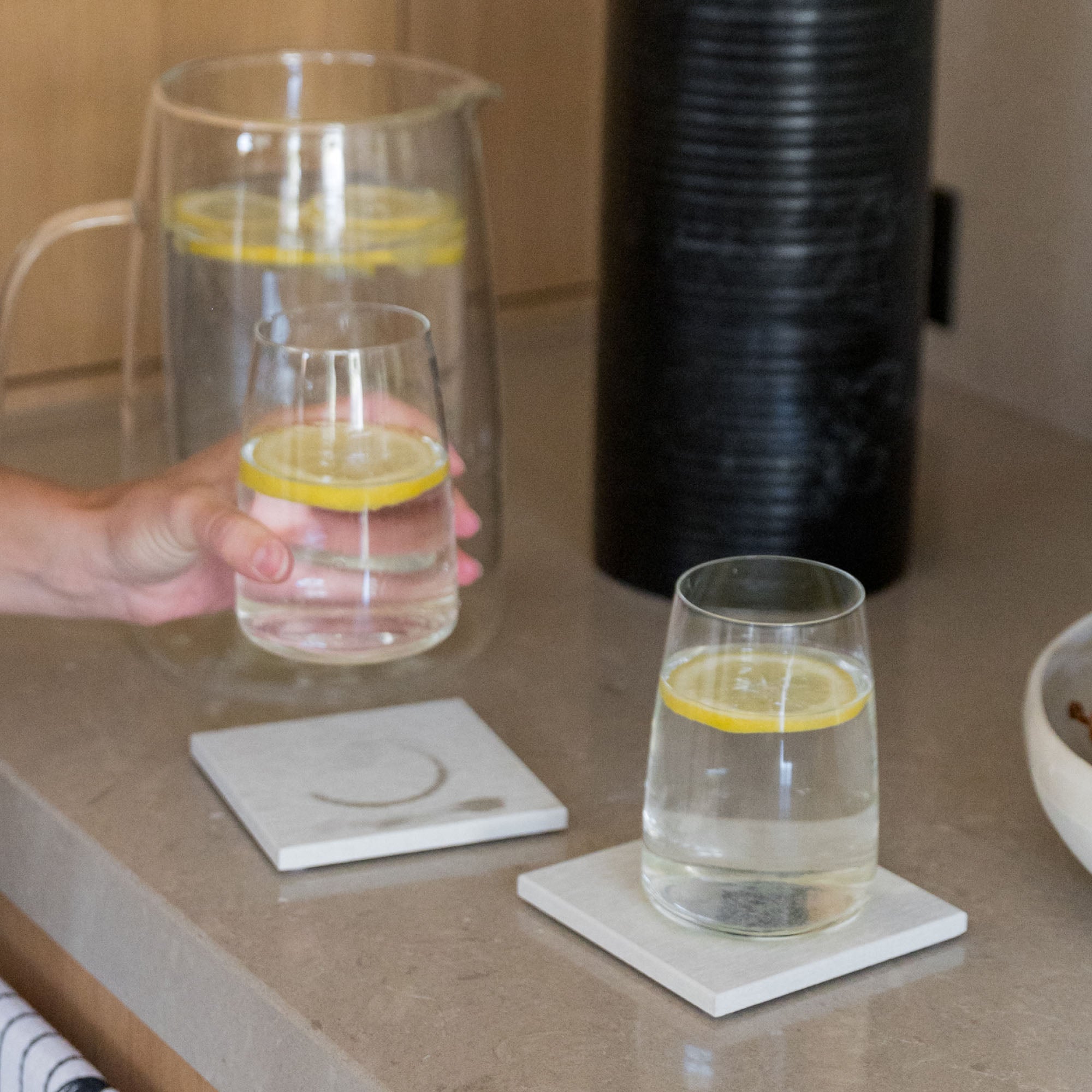 Large Sandstone Coasters with pitcher and cup protecting table from water rings. 