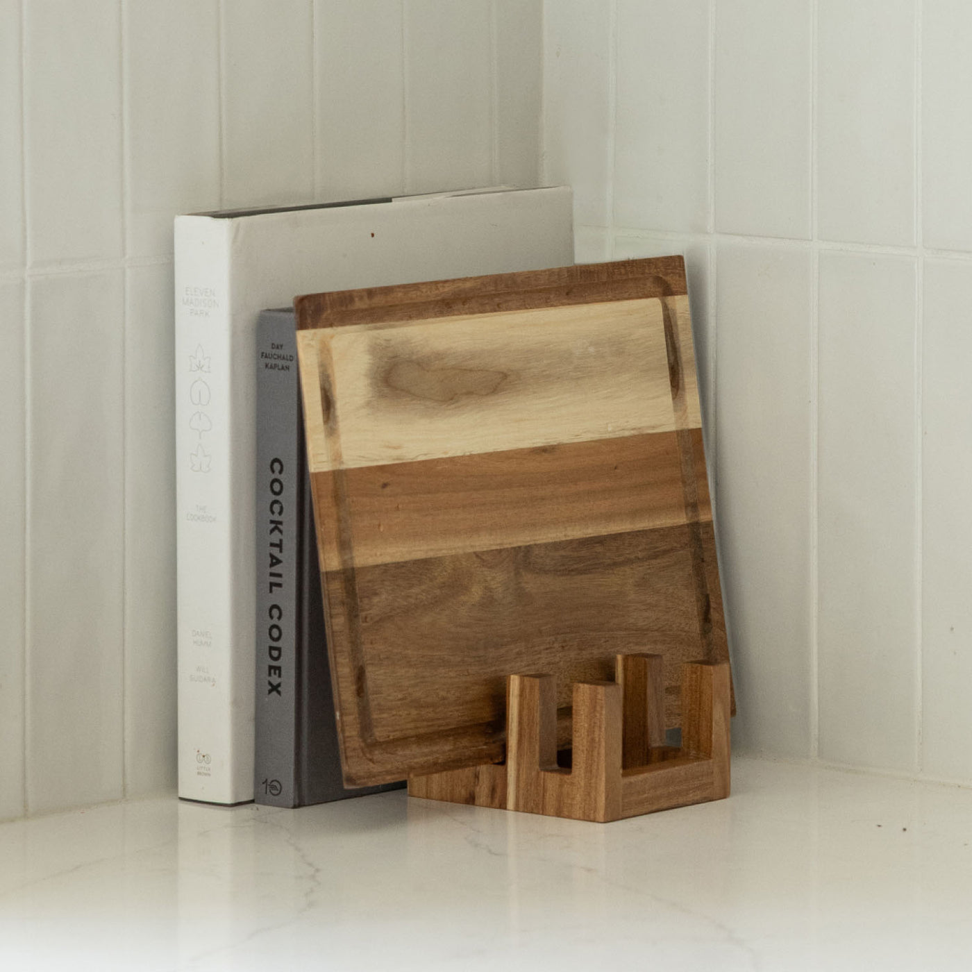 Acacia Cutting Board holder stores beautifully with cookbooks. 
