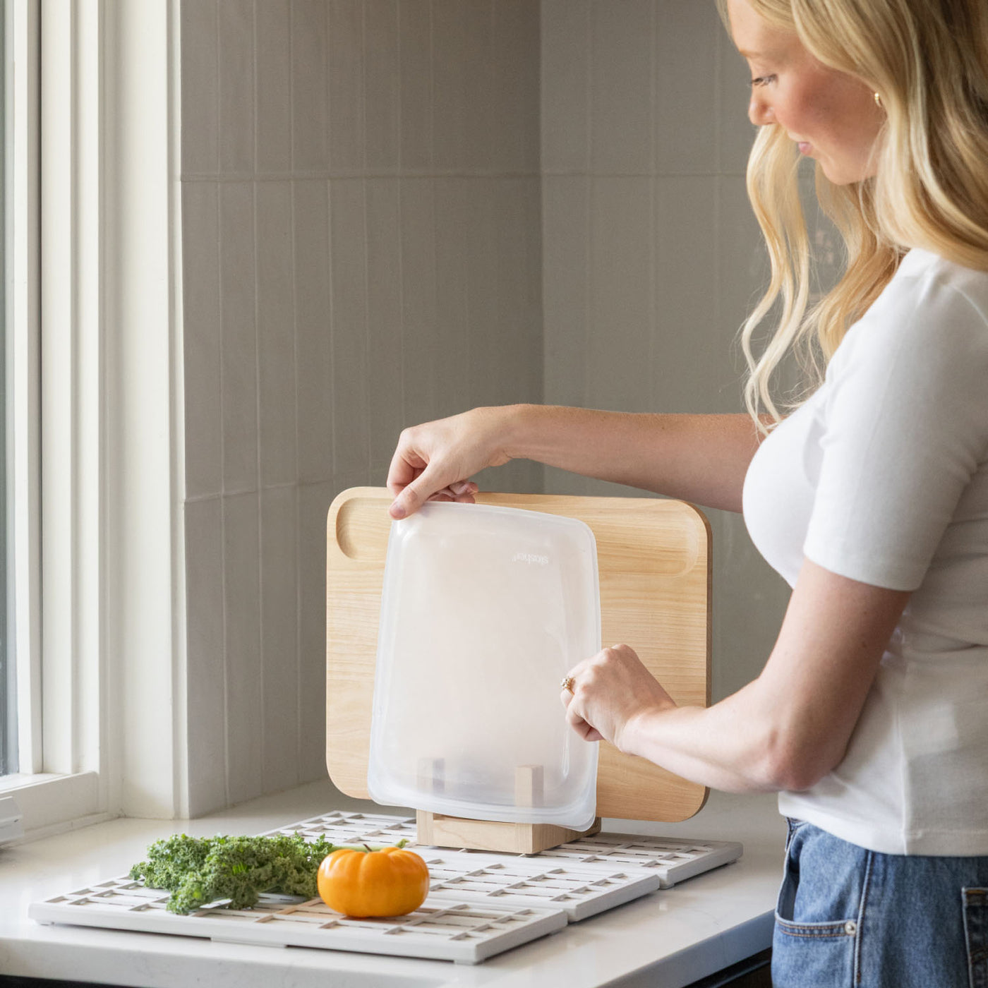 Placing bag to dry on Maple Cutting Board Holder while washing dishes.