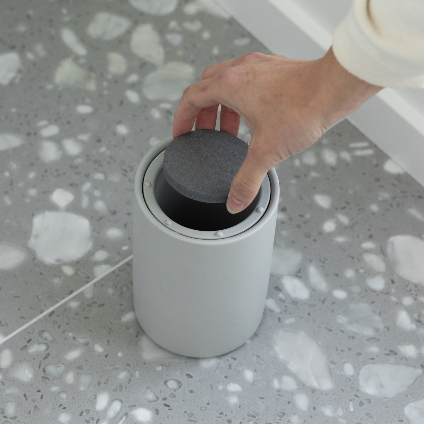 Moisture-absorbing stone for modern toilet brush holder.
