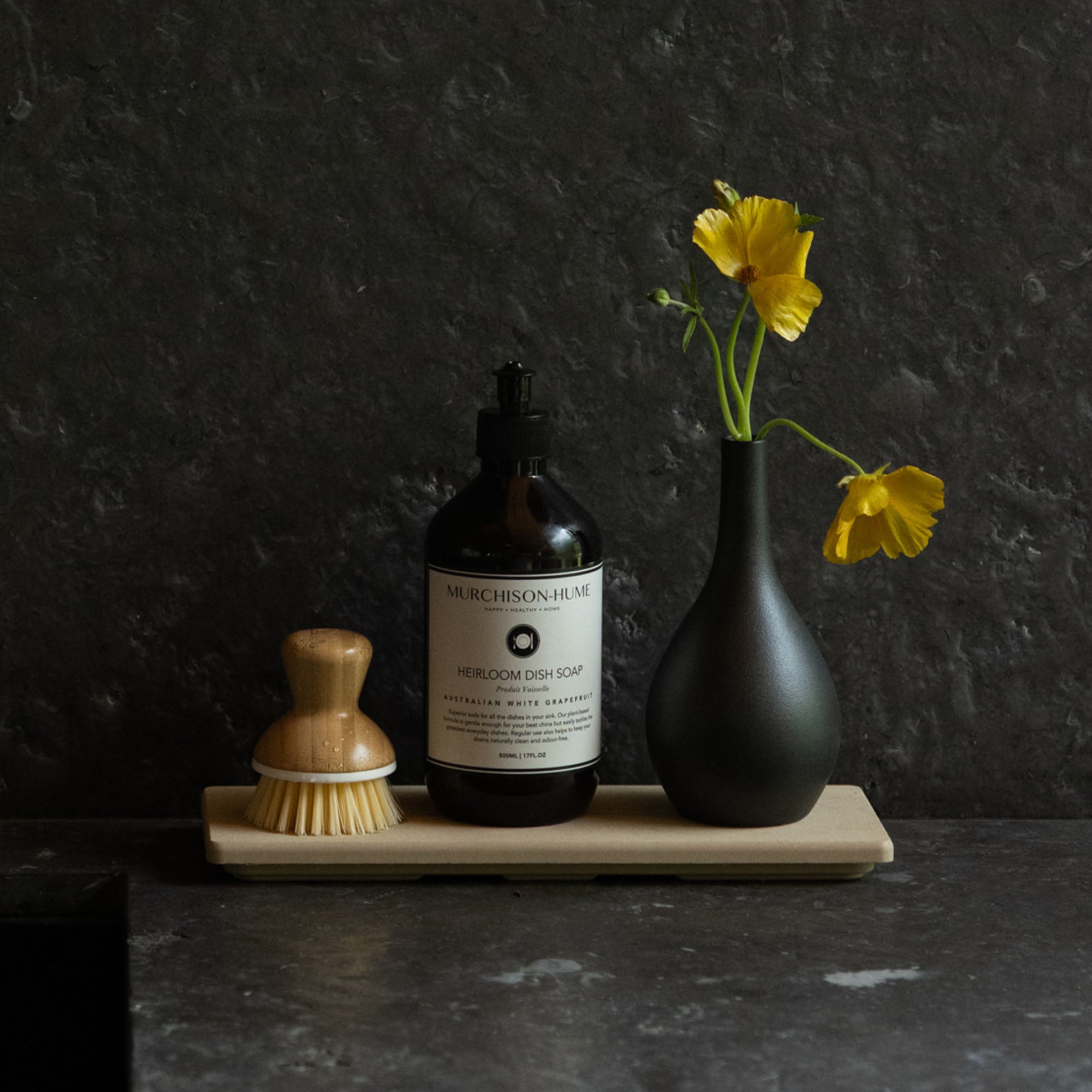 Clay Stone Sink Caddy in modern kitchen with soap and bud vase.