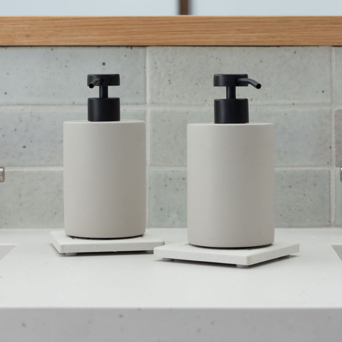 Two Sandstone Soap Caddy with Concrete Soap Dispensers in bathroom.