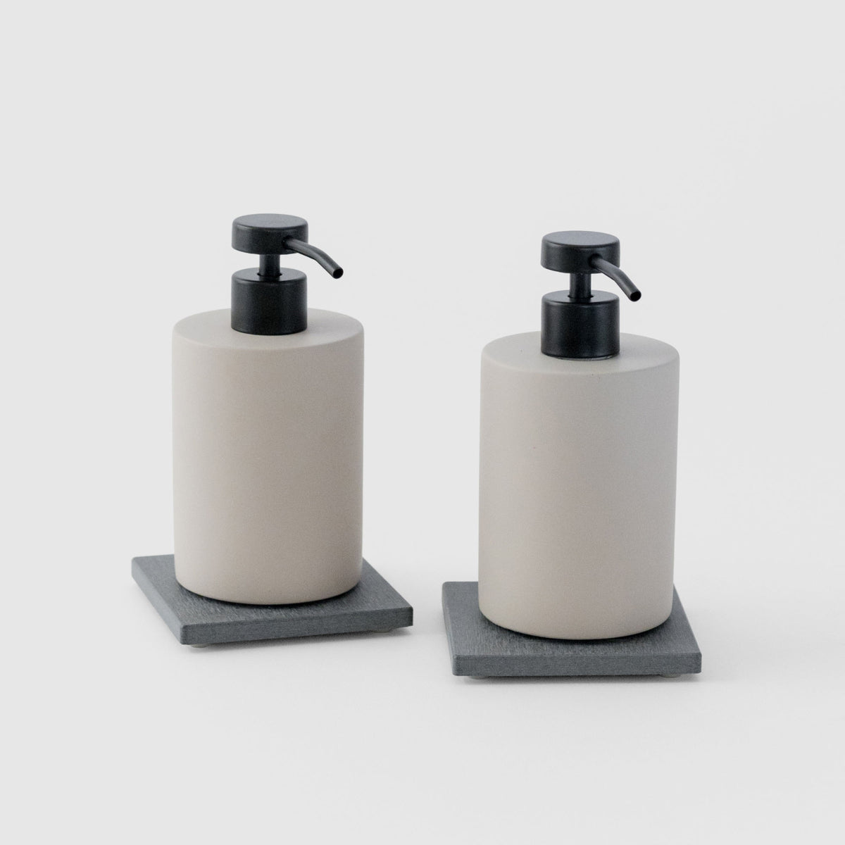 Two Slate Soap Caddy with Concrete Soap Dispensers on white background. 