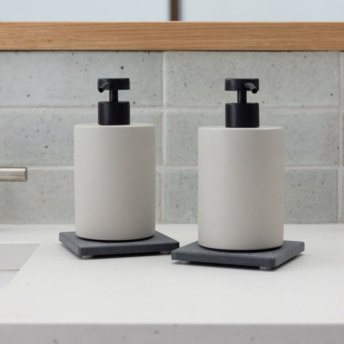 Two Slate Soap Caddy with Concrete Soap Dispensers in bathroom.