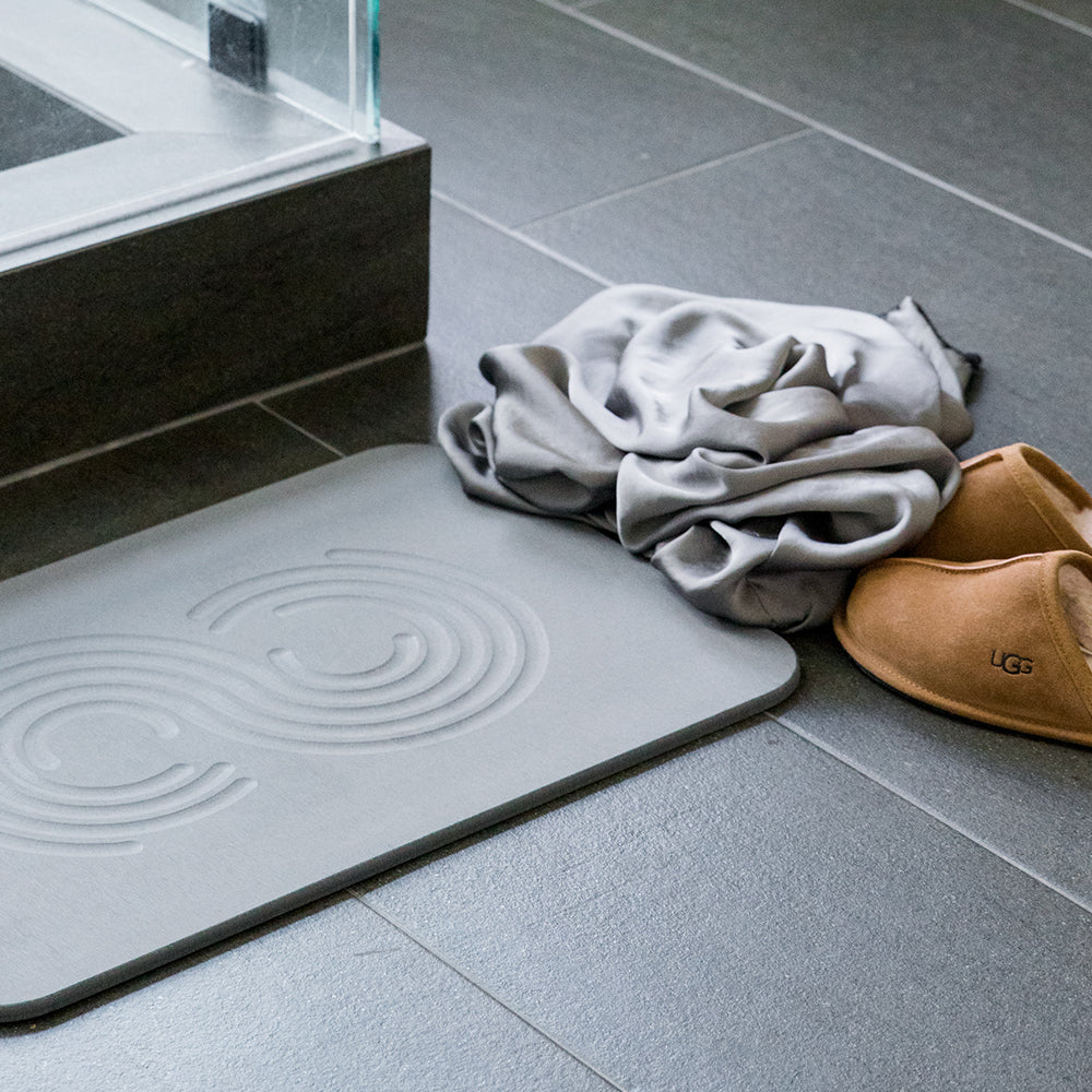 bathroom floor with grey mat