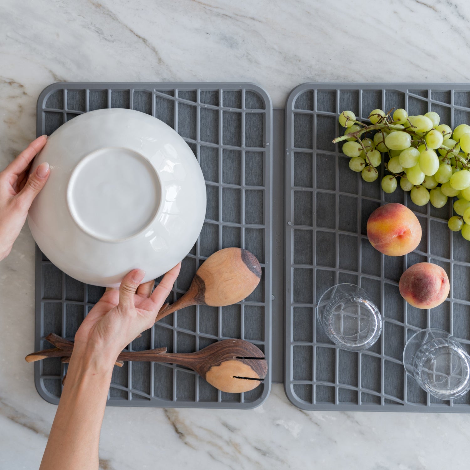 dark grey dish drying pad being used for drying dishes