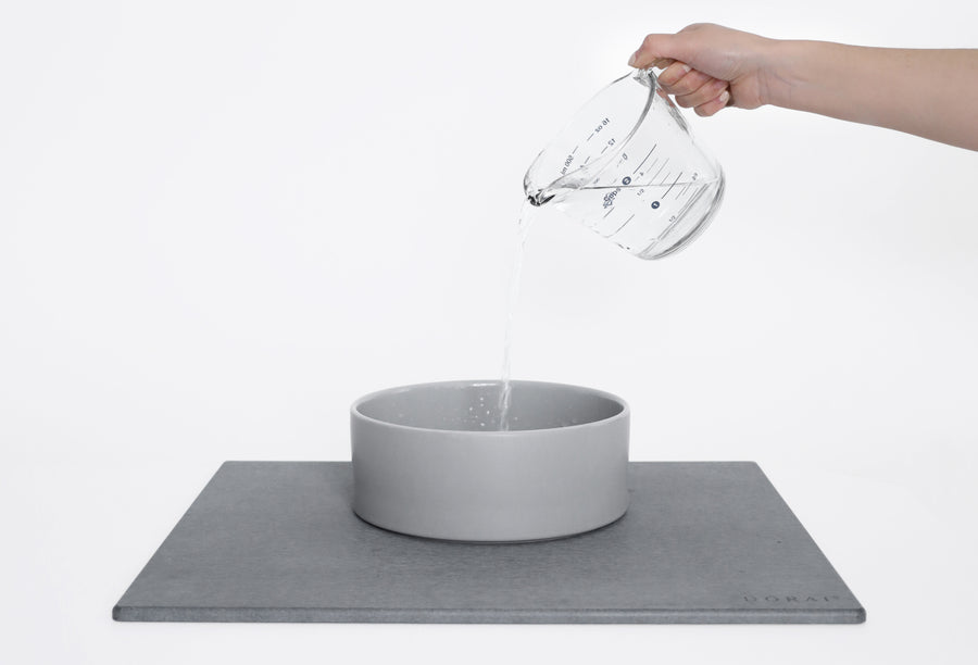 large ceramic water dish being filled with 8 cups of water