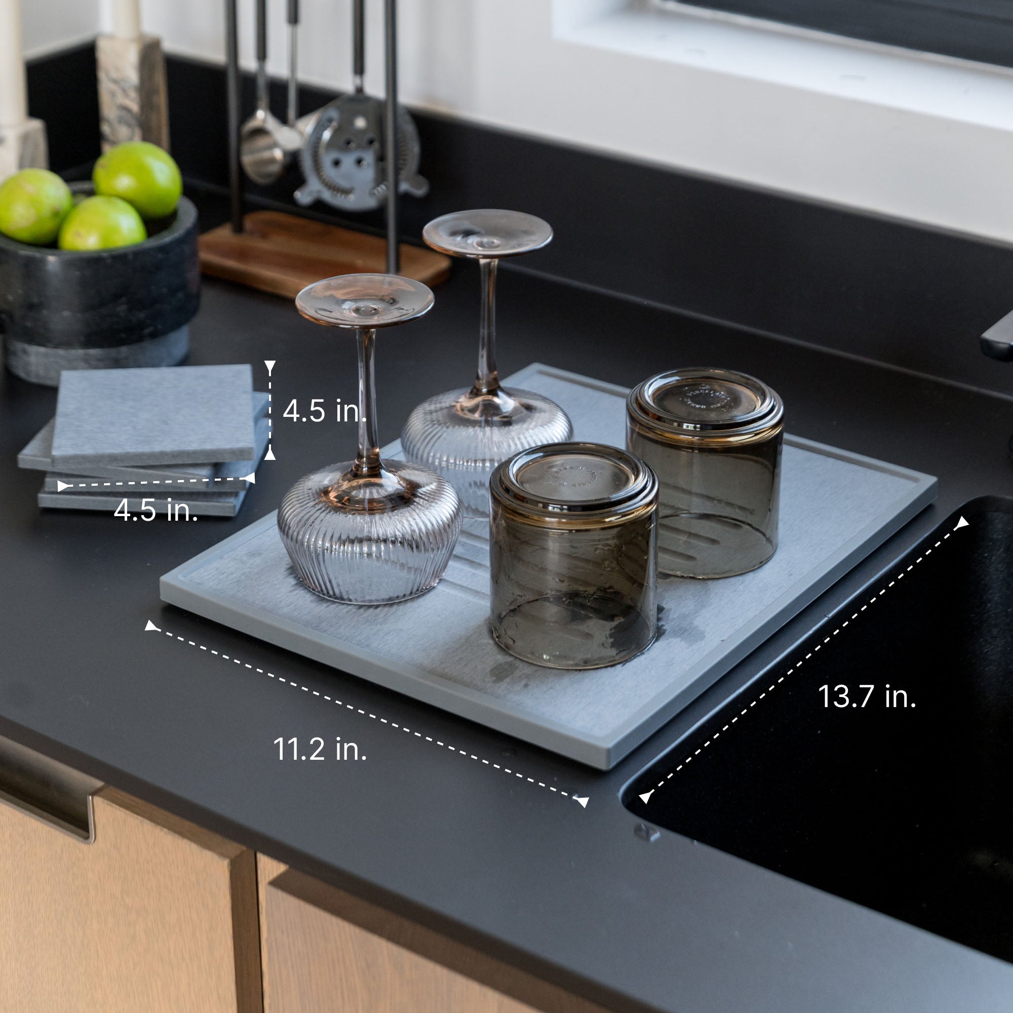 Modern bar set up with glasses on quick-drying mat. 