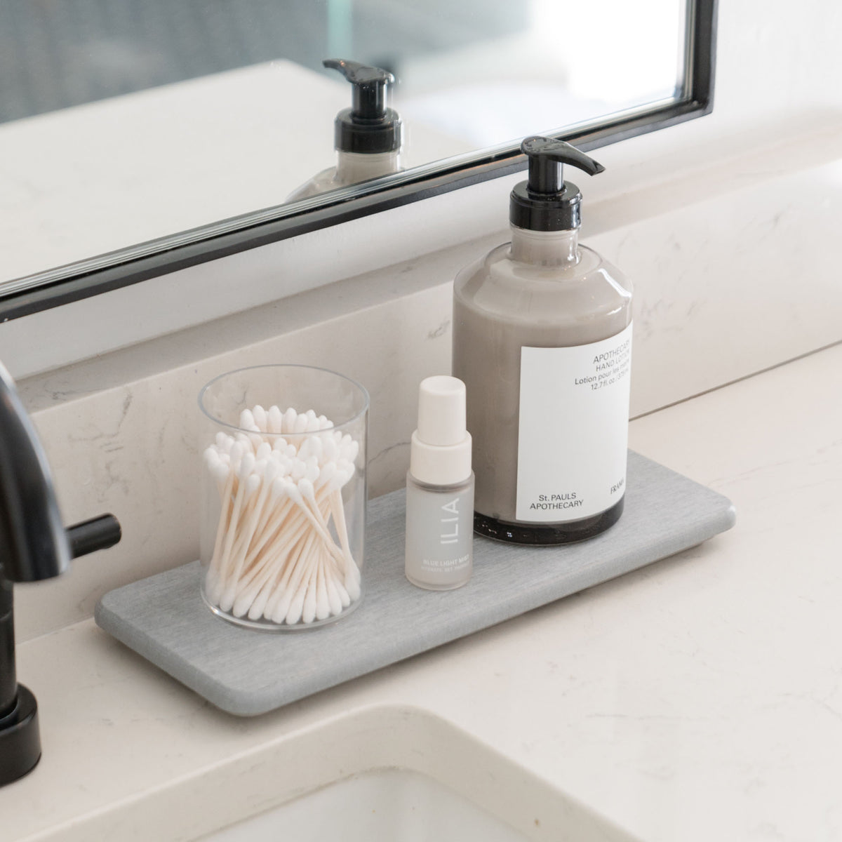 Ash Stone Sink Caddy holds soaps and Q-tips.
