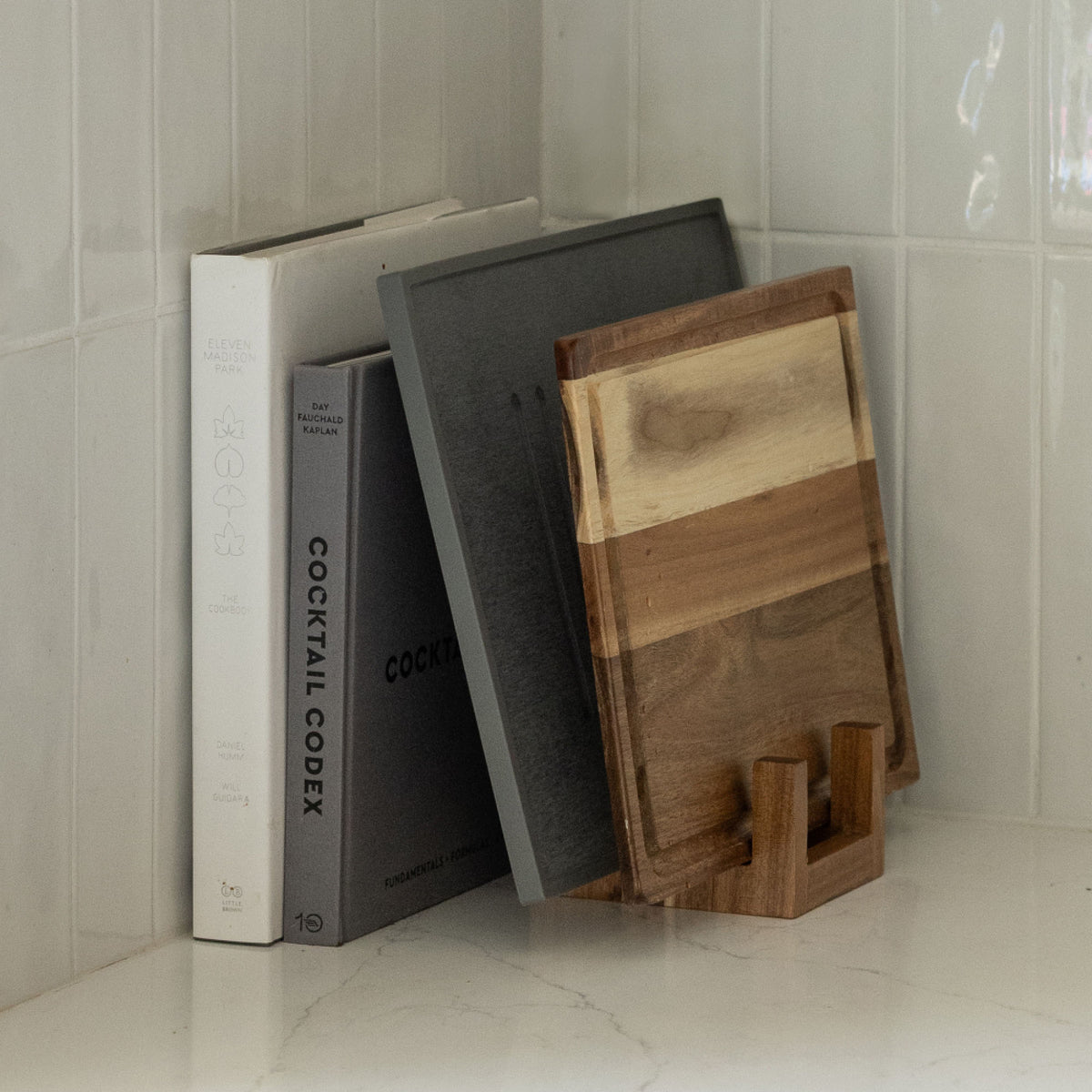Acacia Cutting Board Holder can hold Slate Dish Drying Stone and nestle in with cookbooks.