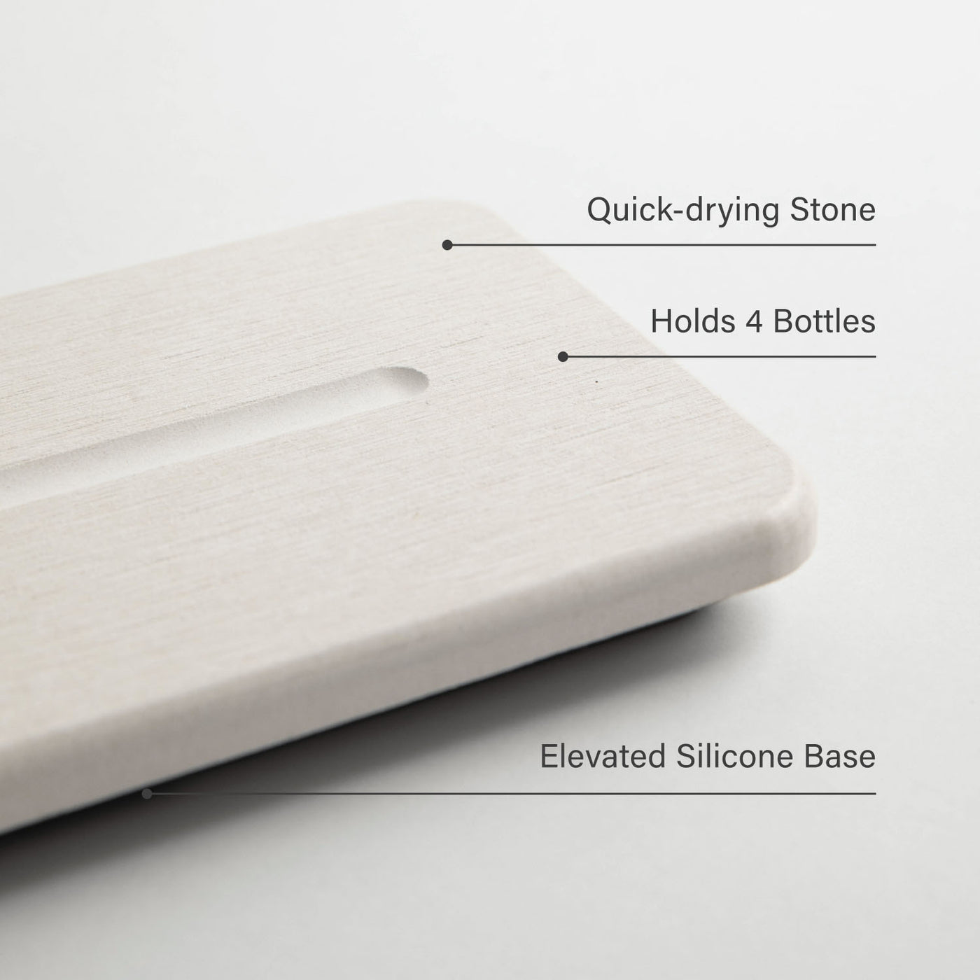 White stone sink caddy with text indicating features like quick-drying stone, holding capacity, and silicone base.