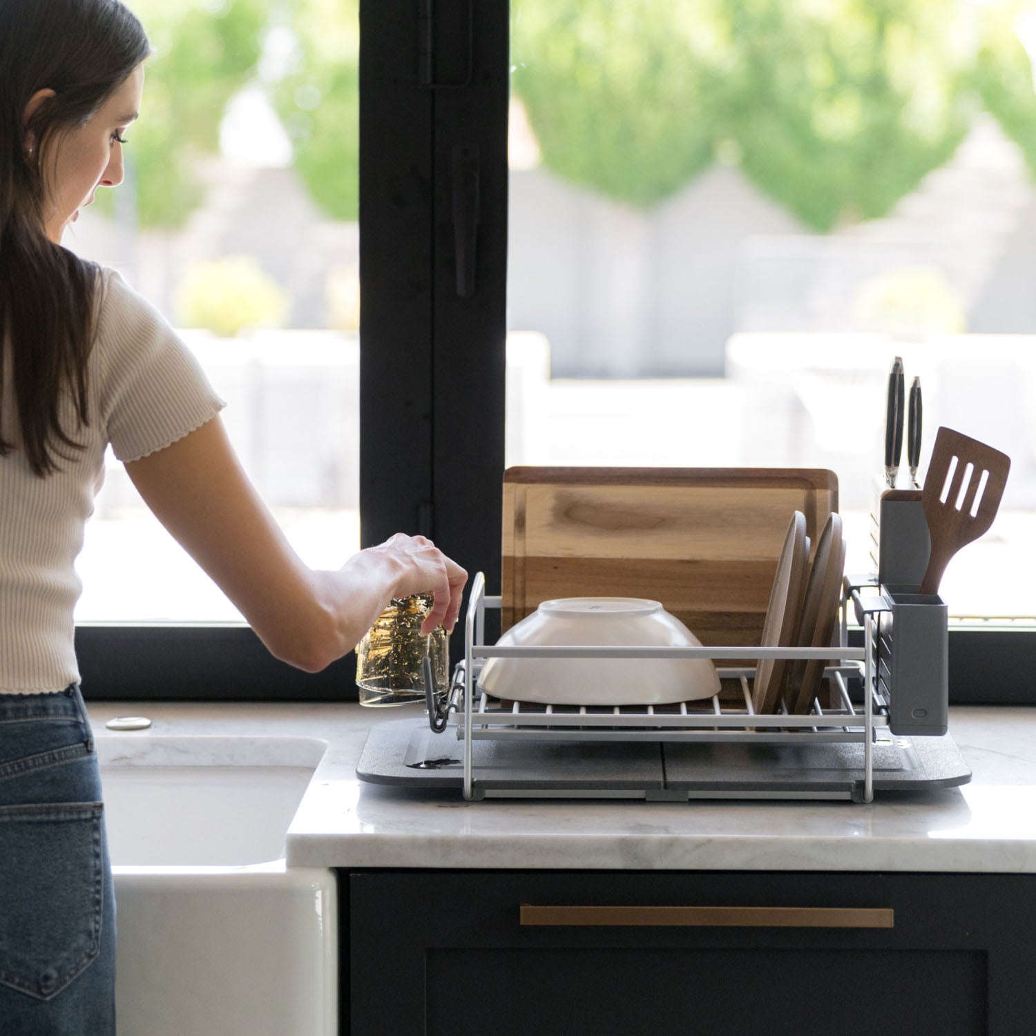 modern dish drying rack with dishes on kitchen counter