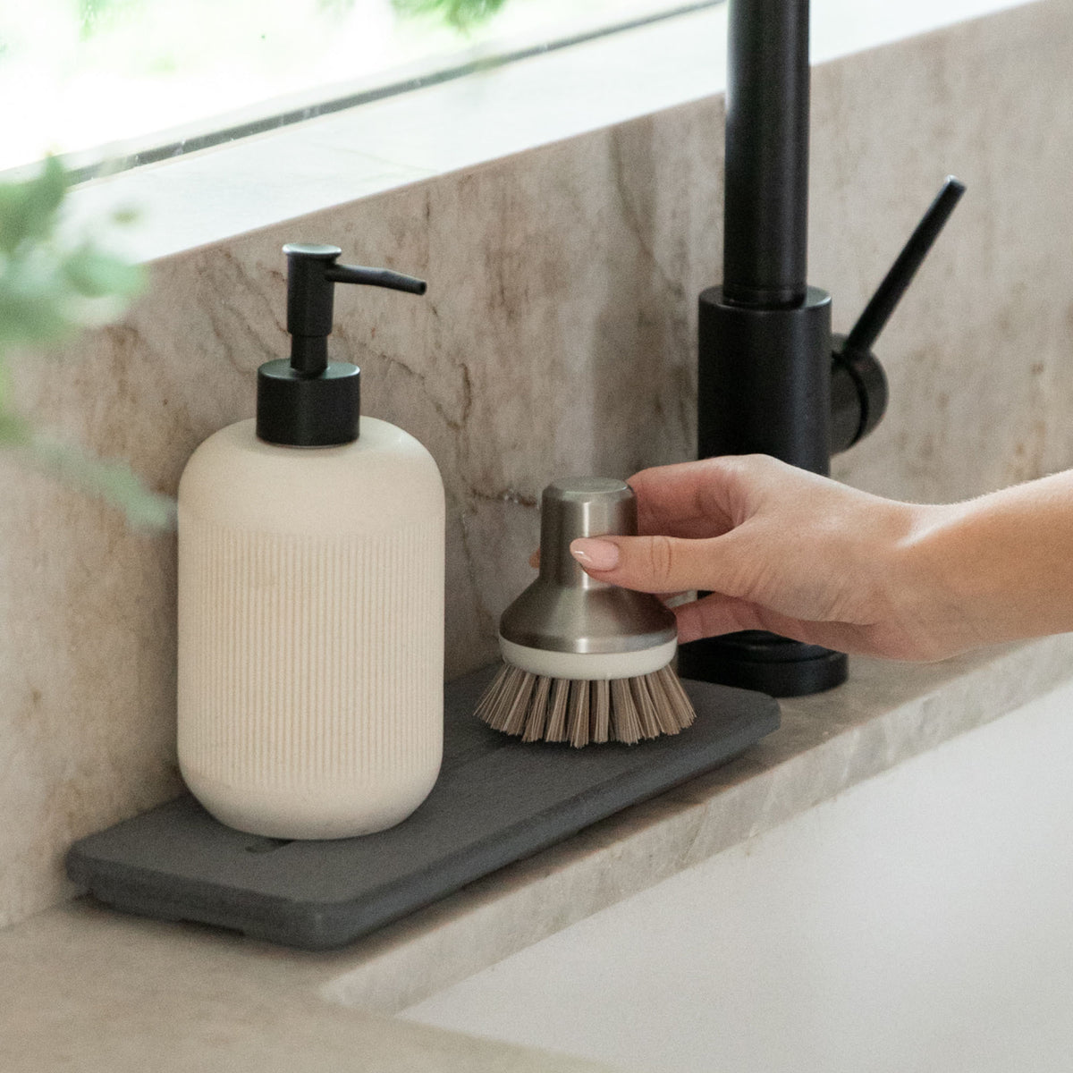 Water quickly drying on Slate Stone Sink Caddy with soaps. 