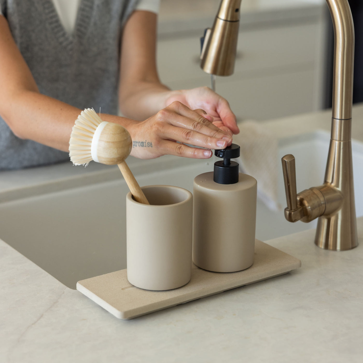 Taupe Soap Dispenser and Clay Stone Sink Caddy in modern kitchen. | Clay Collection Image