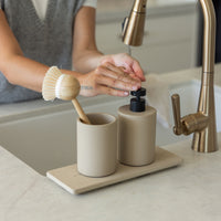 Taupe Soap Dispenser and Clay Stone Sink Caddy in modern kitchen. | Clay Collection Image