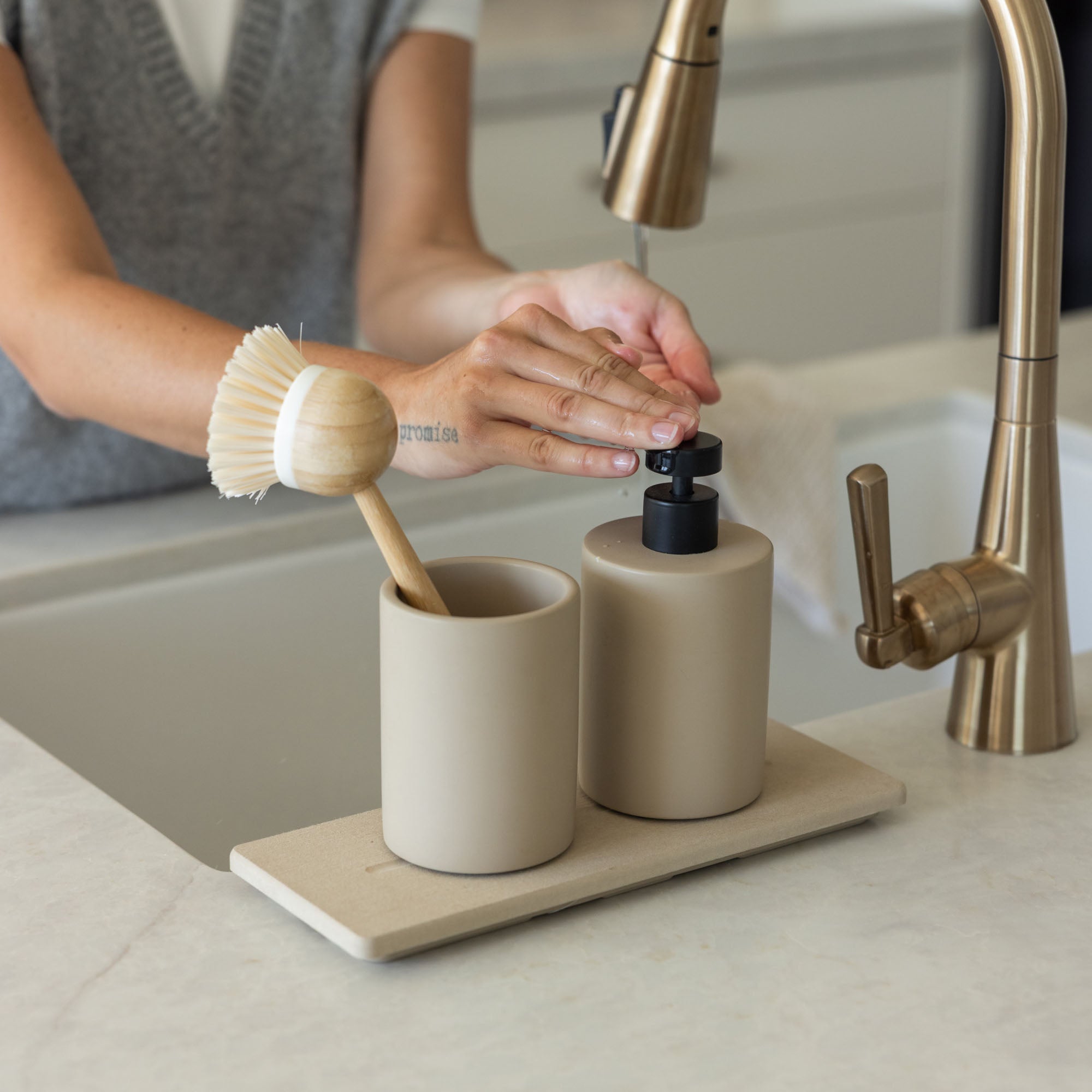 Taupe Soap Dispenser and Clay Stone Sink Caddy in modern kitchen. | Clay Collection Image