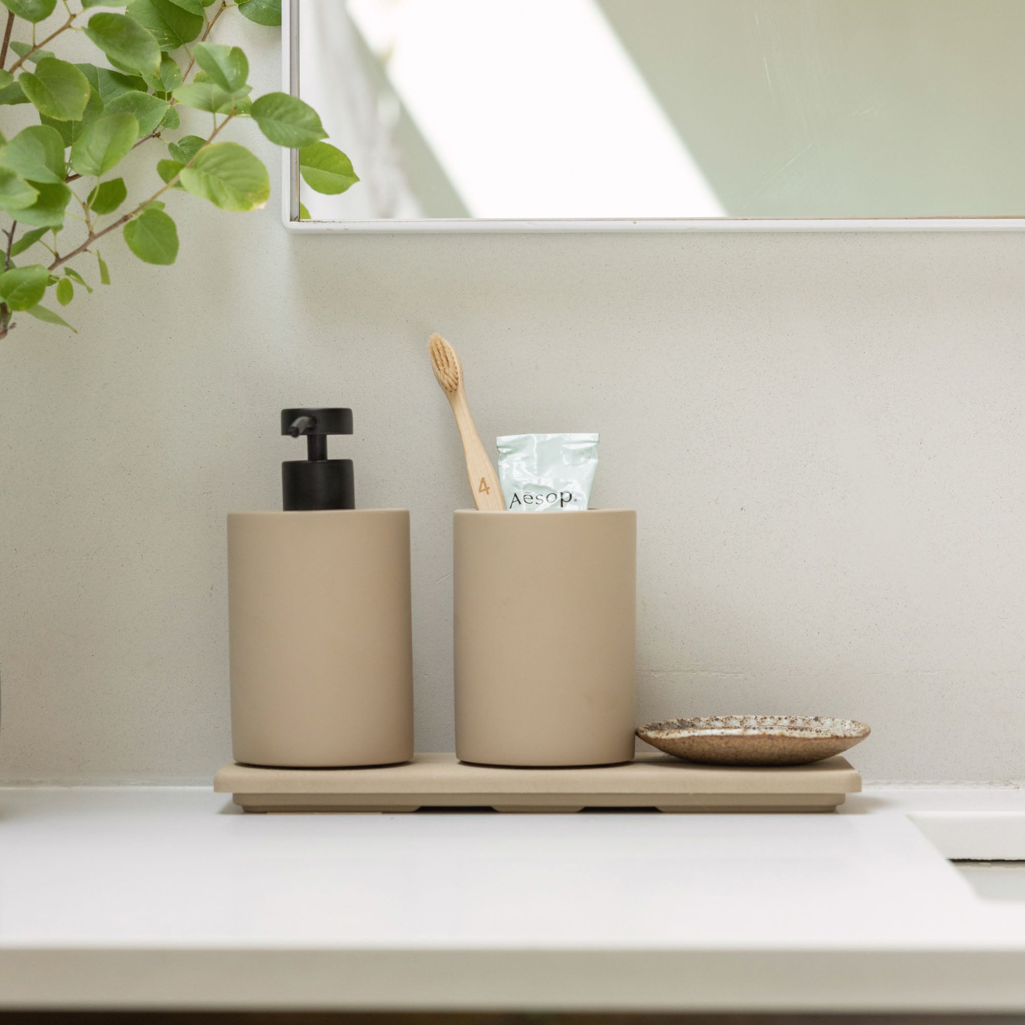 Modern Stone Sink Set in Taupe and Clay in elegant bathroom. 