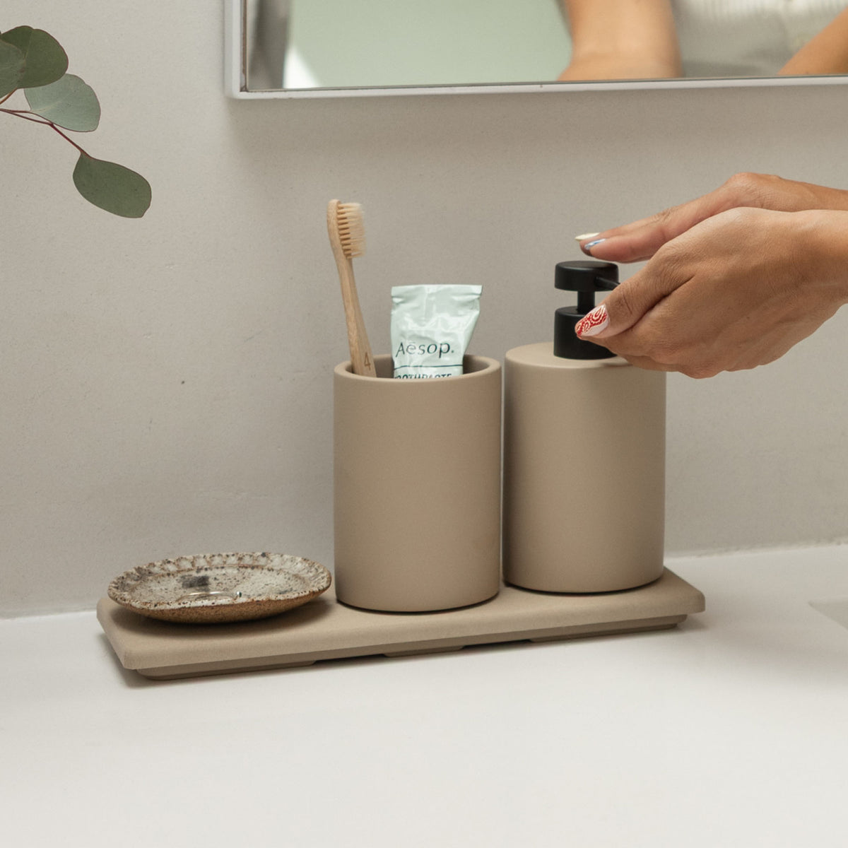 Clay Stone Sink Caddy holds soaps and other bathroom items. 