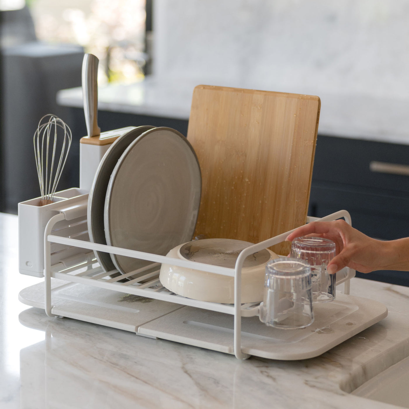 Quick-drying stone under glacier dish rack with lots of dishes. 