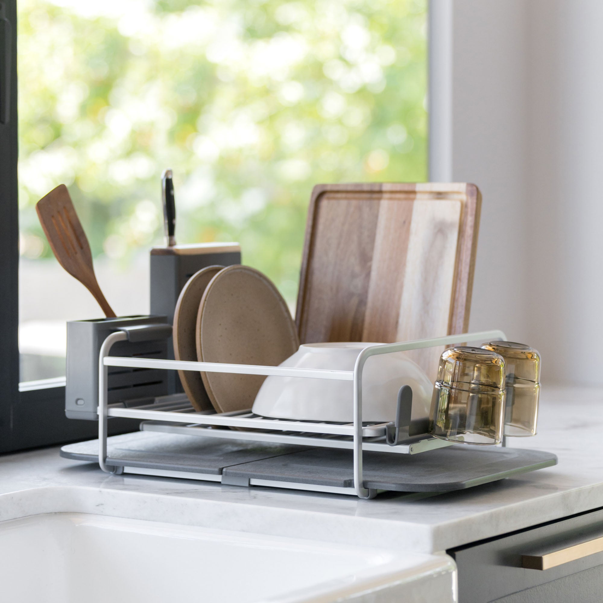 Slate dish rack full loaded in modern kitchen. 