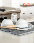 Slate dish pad with dishes on kitchen counter