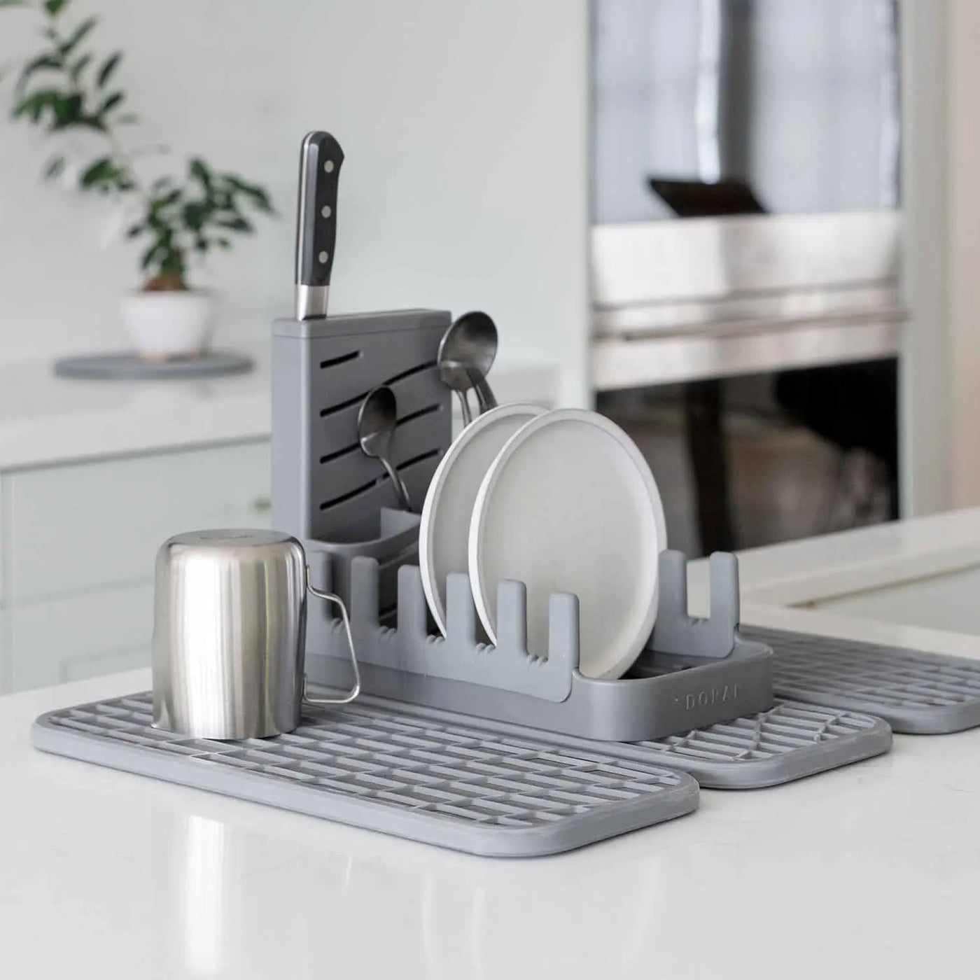 slate dish pad rack on slate dish pad with dishes and utensils on kitchen counter