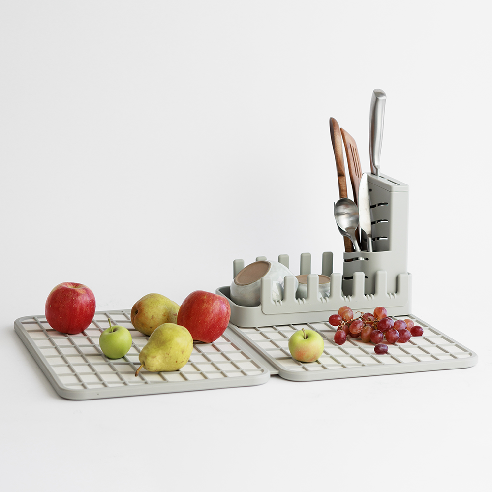 knives and utensils being dried in dish holder on large dish pad