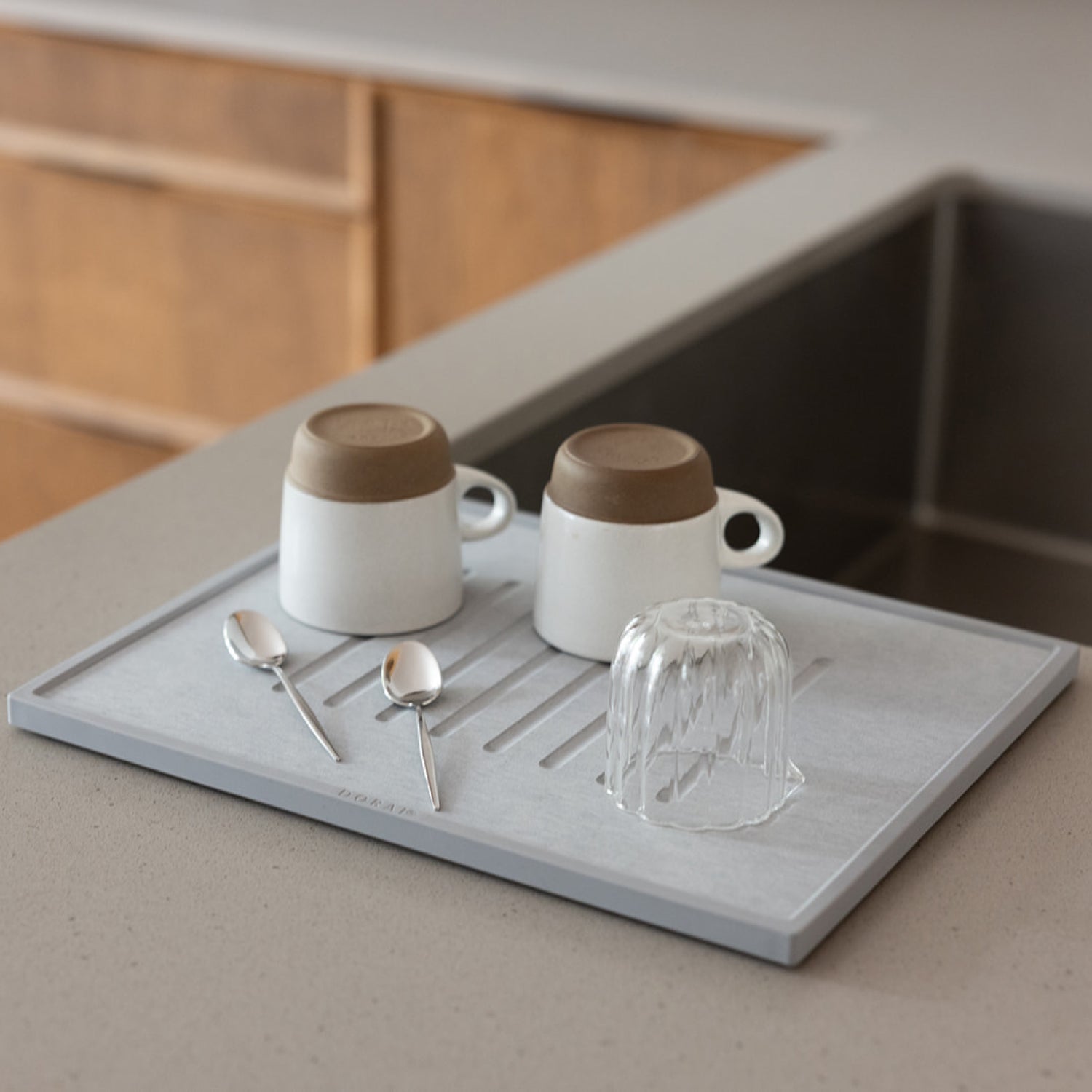 coffee mugs and creamer drying on modern dish drying pad