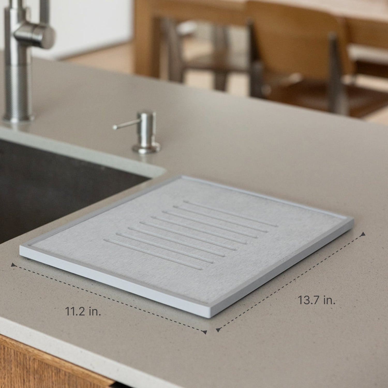 Gray dish drying mat on a kitchen counter with measurements indicated