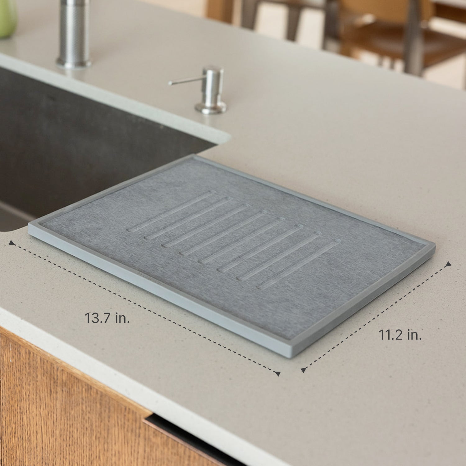 Gray dish drying stone on a kitchen counter with measurements indicated