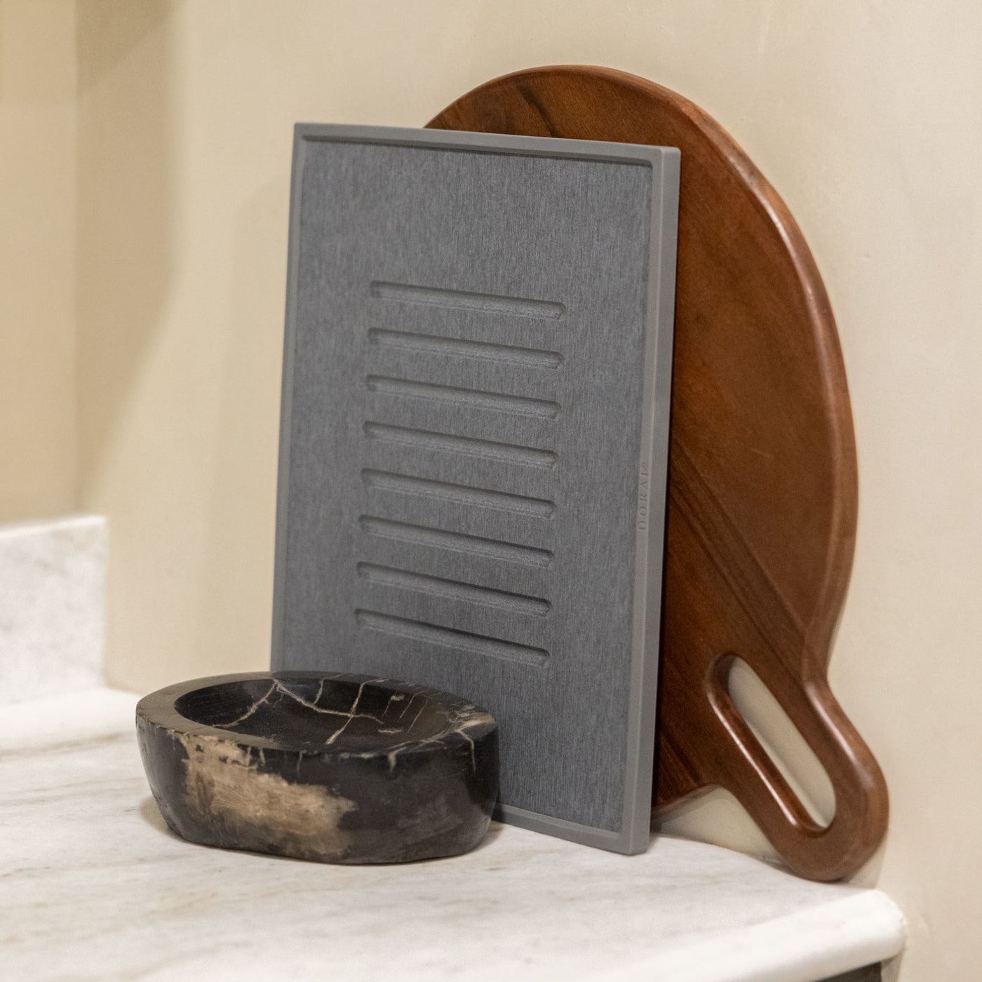 Beautiful slate dish mat with modern, wood cutting board for minimalist kitchen.