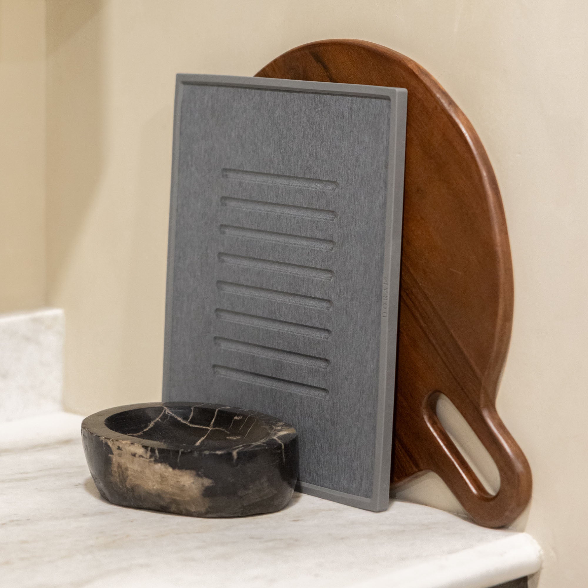 Beautiful slate dish mat with modern, wood cutting board for minimalist kitchen.