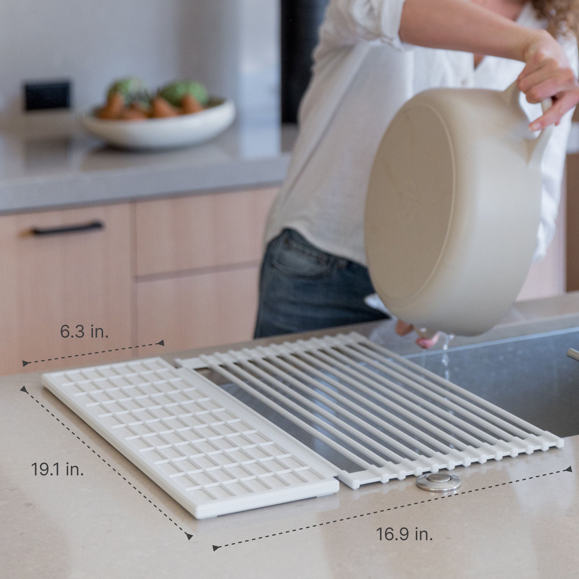dish pad rolled over a kitchen sink with measurements overlaid