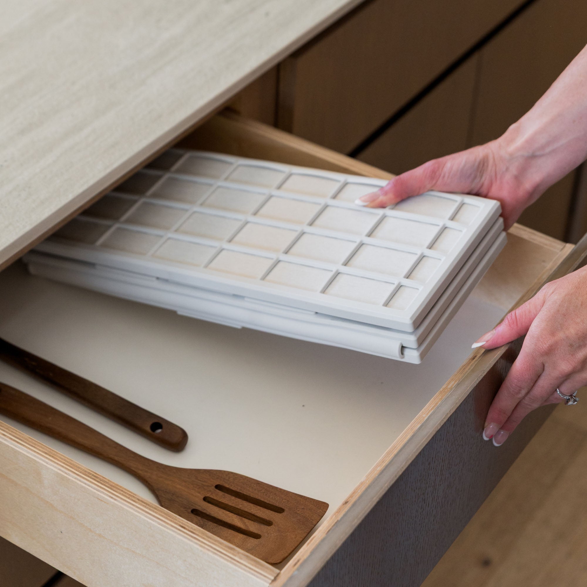 Ridge Dish Pad in Glacier folds neatly in drawer.