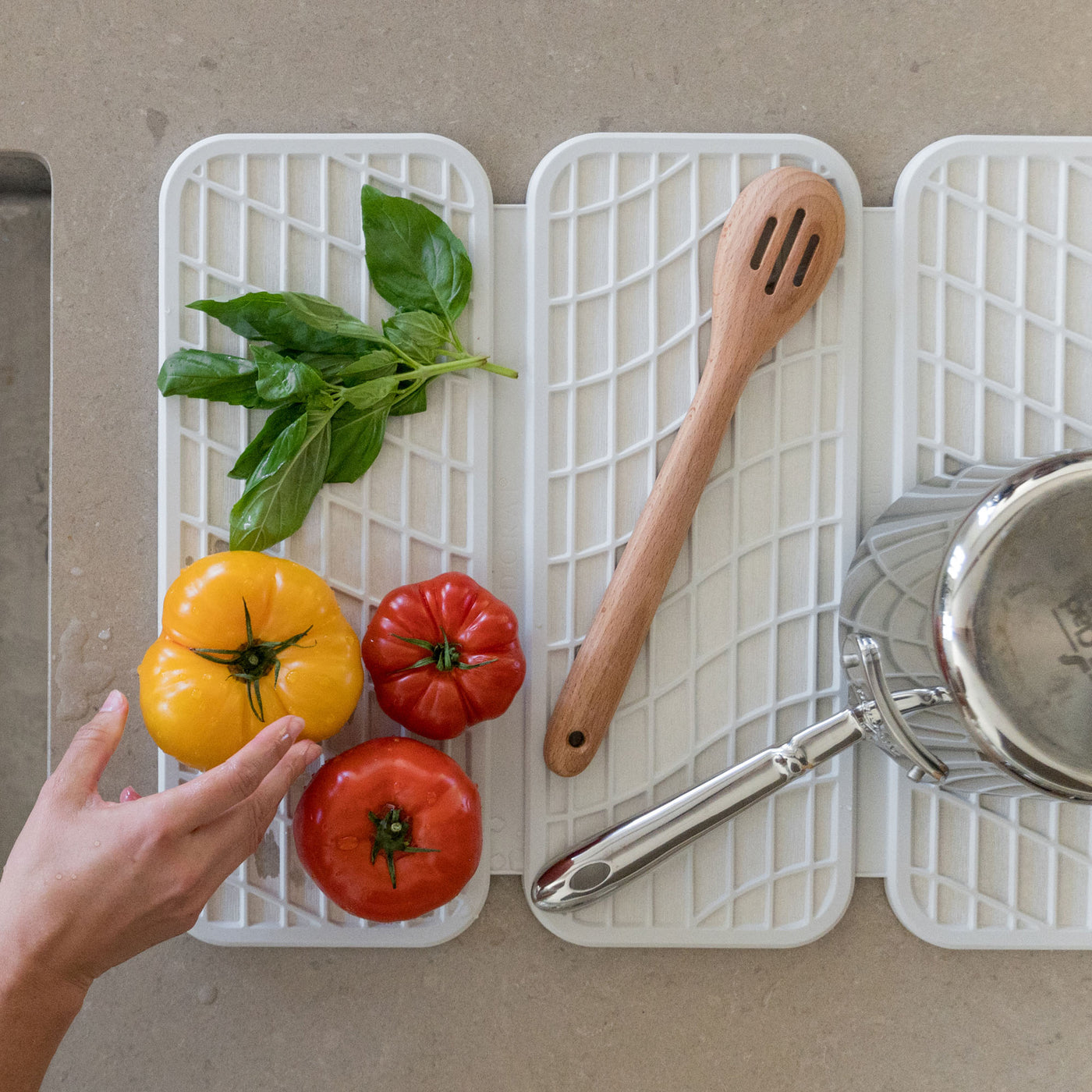 Drift Glacier Dish Pad with produce, pots, and cooking utensil.
