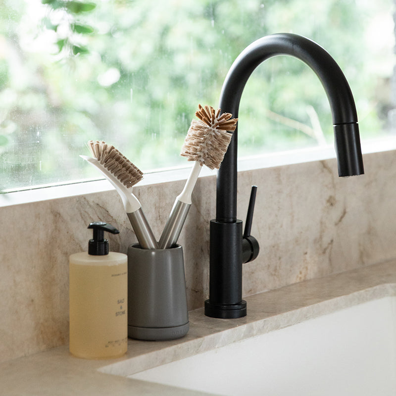 kitchen countertop with ceramic brush holder and dish brush set