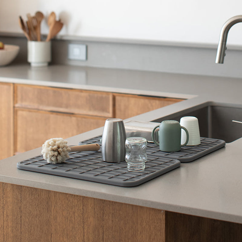 baby bottle drying on dark grey dish drying pad