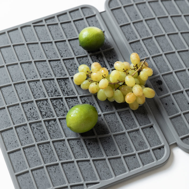 fruit being dried on stone mat