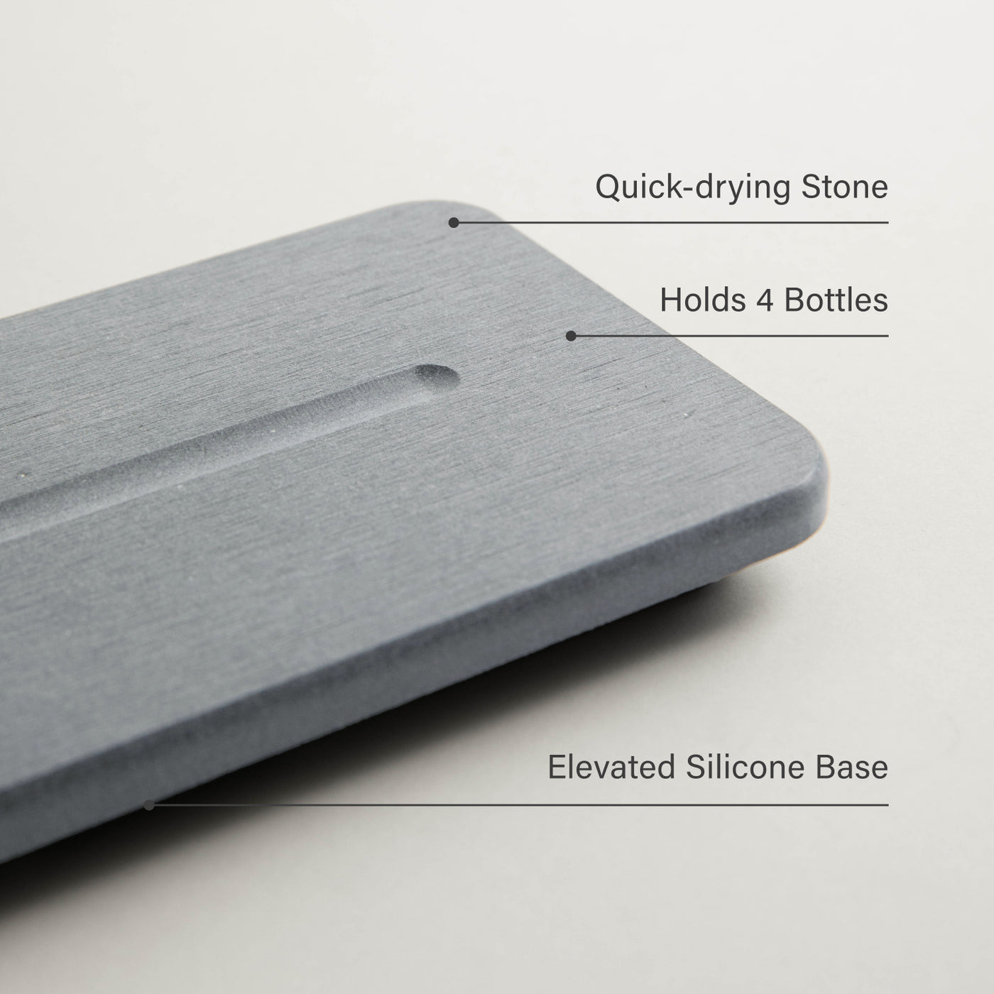 Gray stone that holds 4 bottles with features labeled on a light gray background
