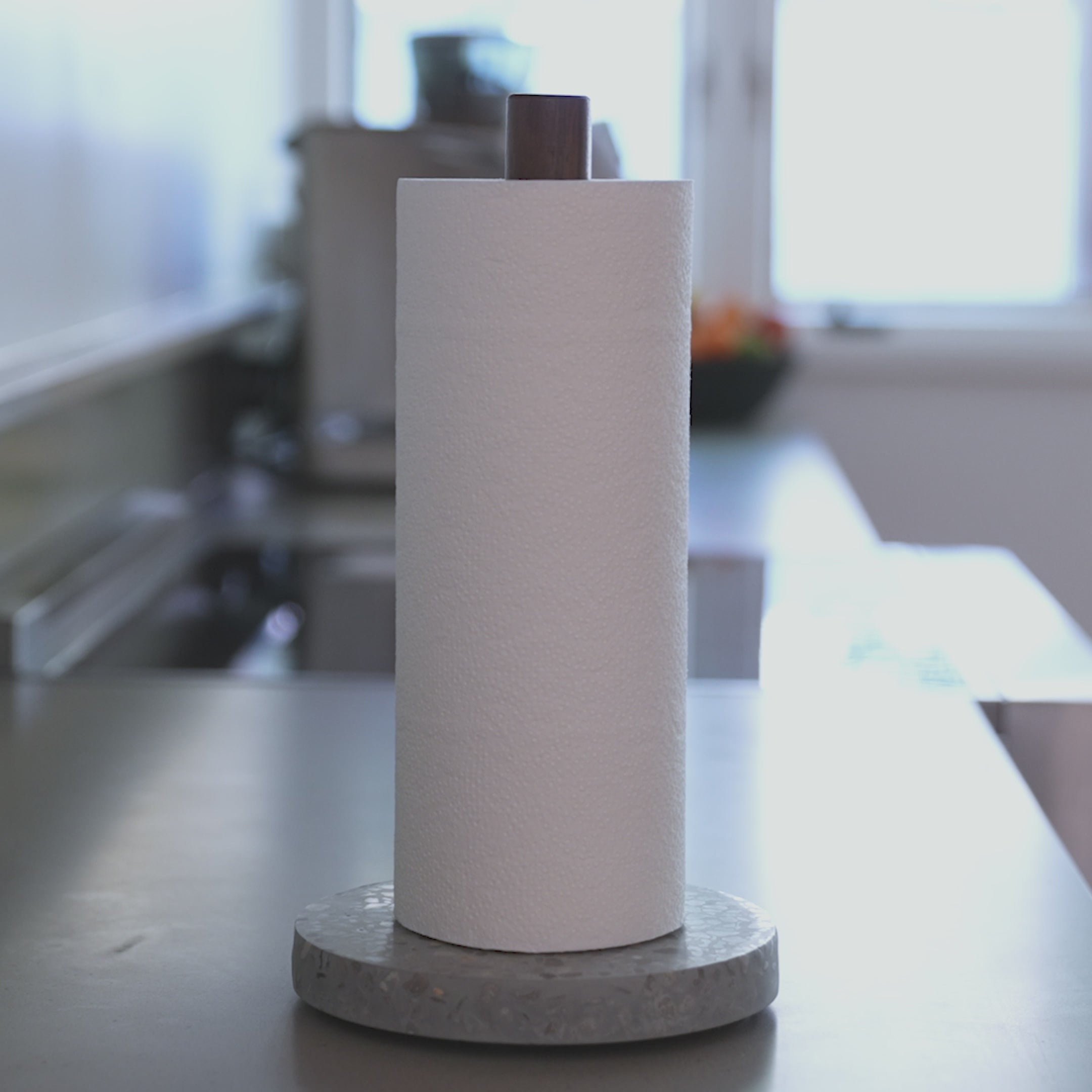 Easily ripping a paper towel with one hand on the Basalt Paper Towel Holder. 