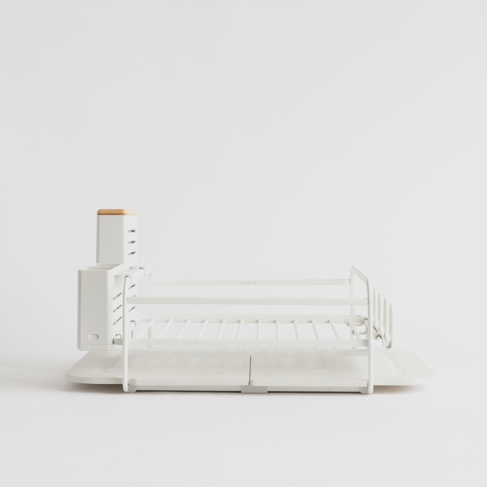 white dish rack being filled with kitchen dishes