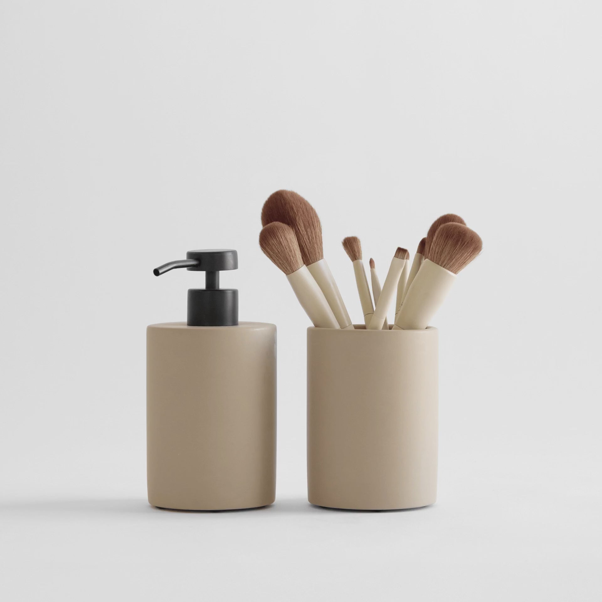 Taupe soap dispenser and versatile dish brush for bathroom or kitchen items.