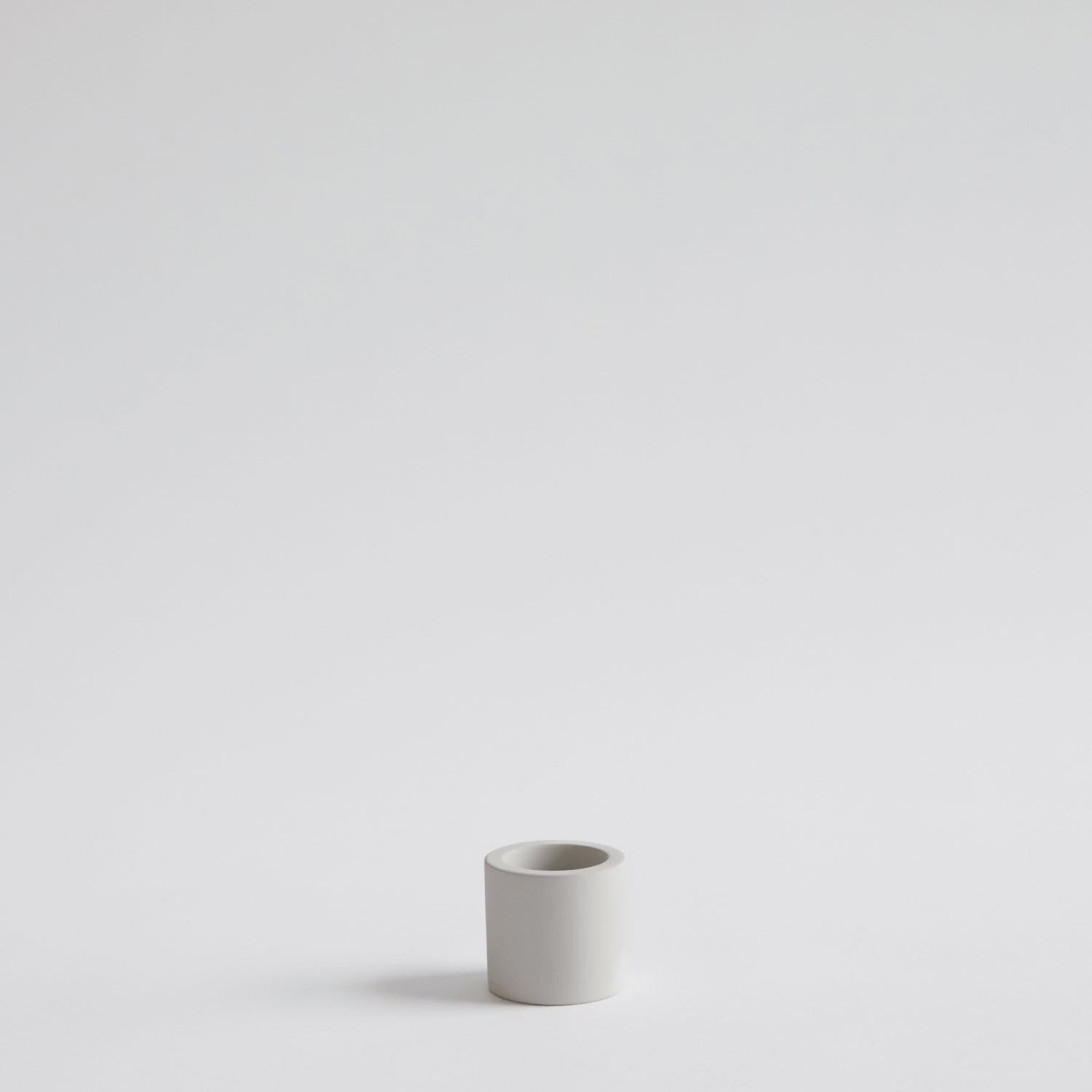 video of hand placing electric toothbrush into stone toothbrush holder