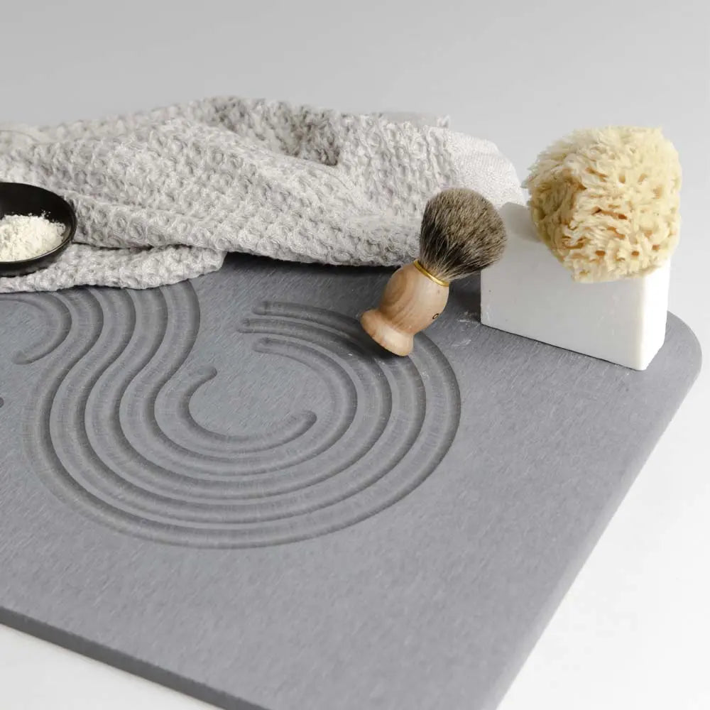 slate zen bath stone mat with a towel an sponge and soap