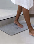 Bath Stone Mat Rain Slate with woman walking off of it from shower