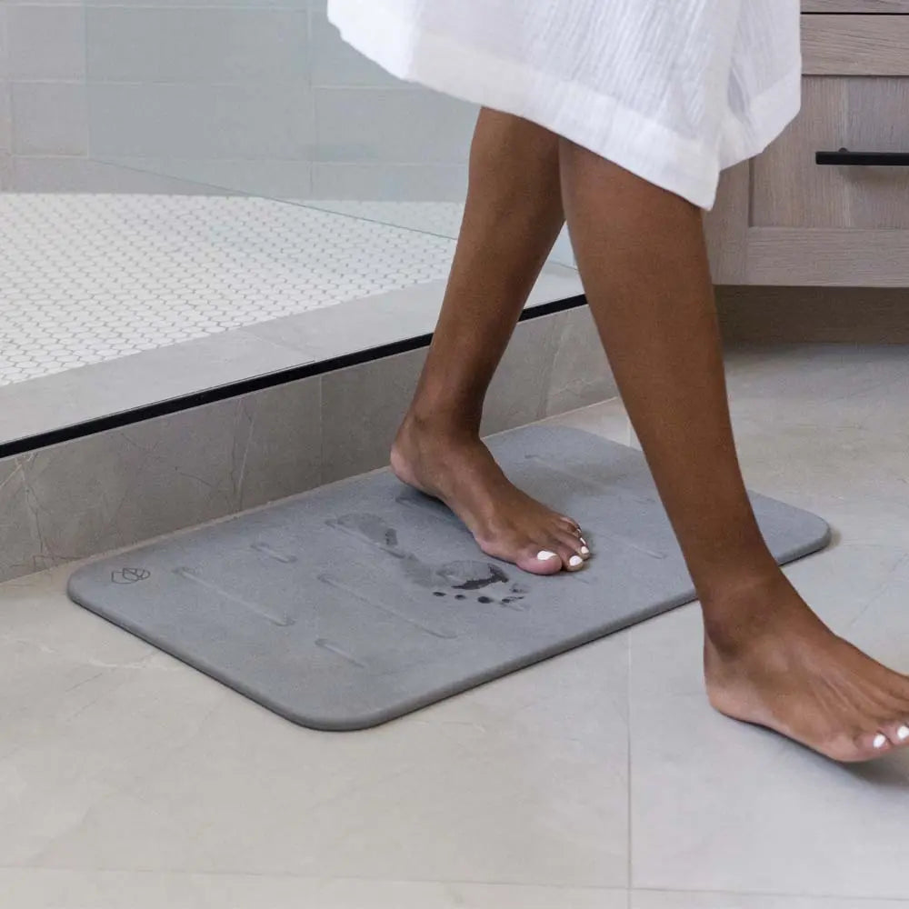 Bath Stone Mat Rain Slate with woman walking off of it from shower