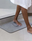 woman stepping onto rain slate bath stone out of the shower