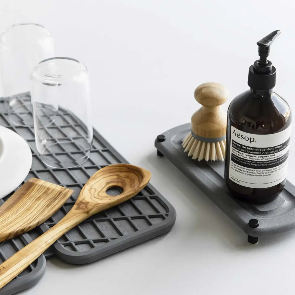 slate dish pad with utensils and glassware and slate sink caddy with scrubber and soap